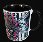 Black mug with skull and rose design on a wooden surface