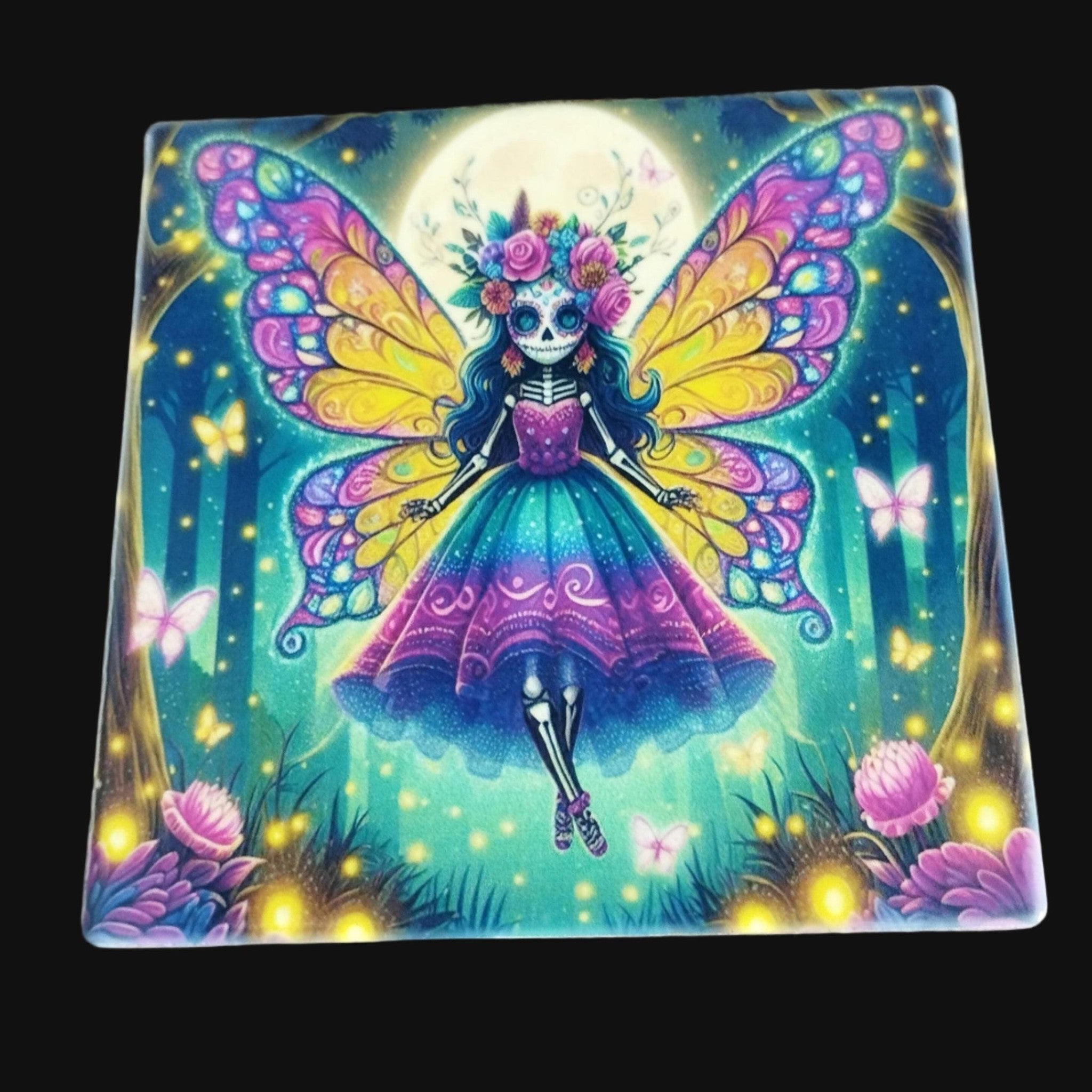 Colorful fairy with butterfly wings on a wooden surface