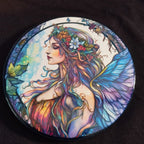 Colorful artwork of a fairy with floral hair and butterfly wings on a dark background