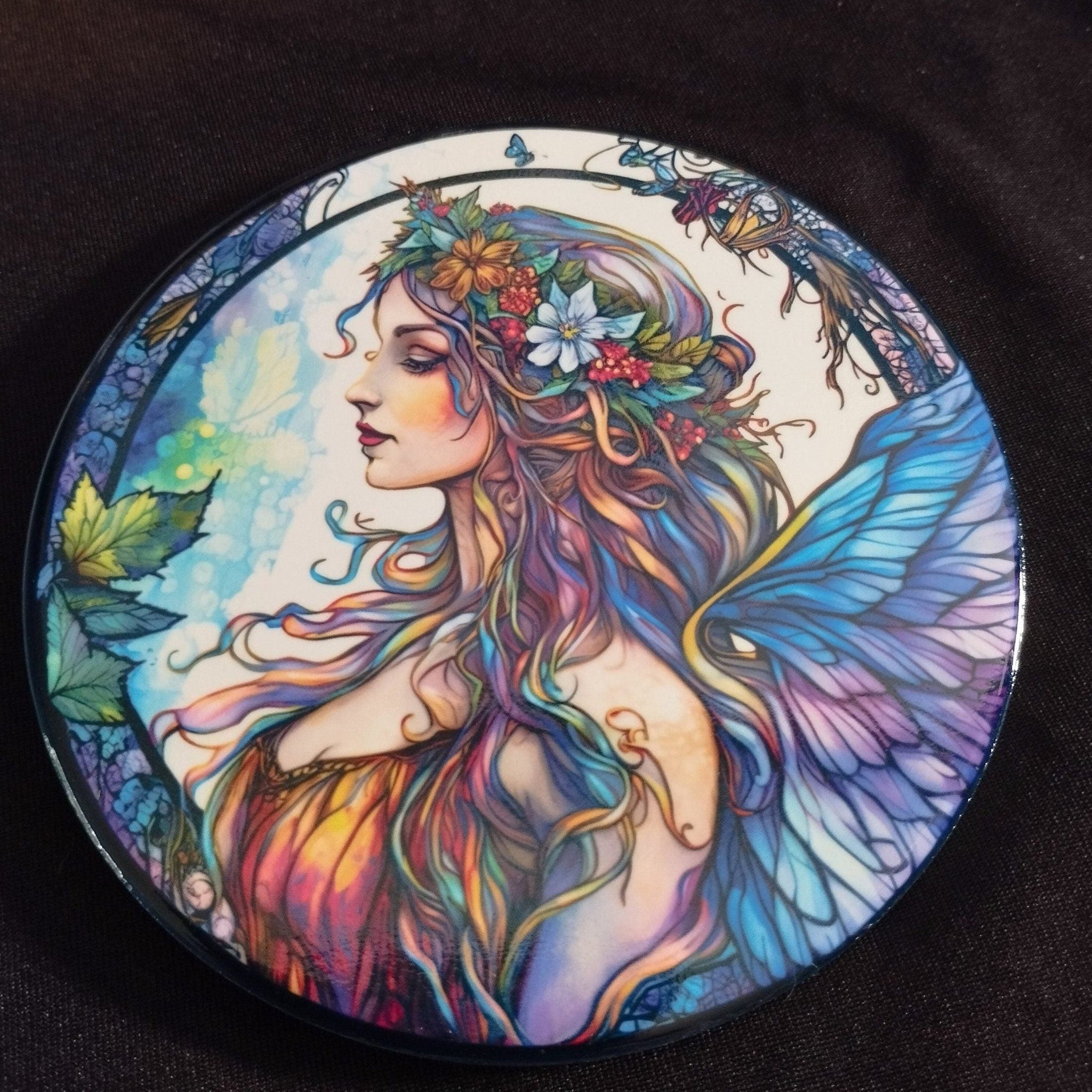 Colorful artwork of a fairy with floral hair and butterfly wings on a dark background