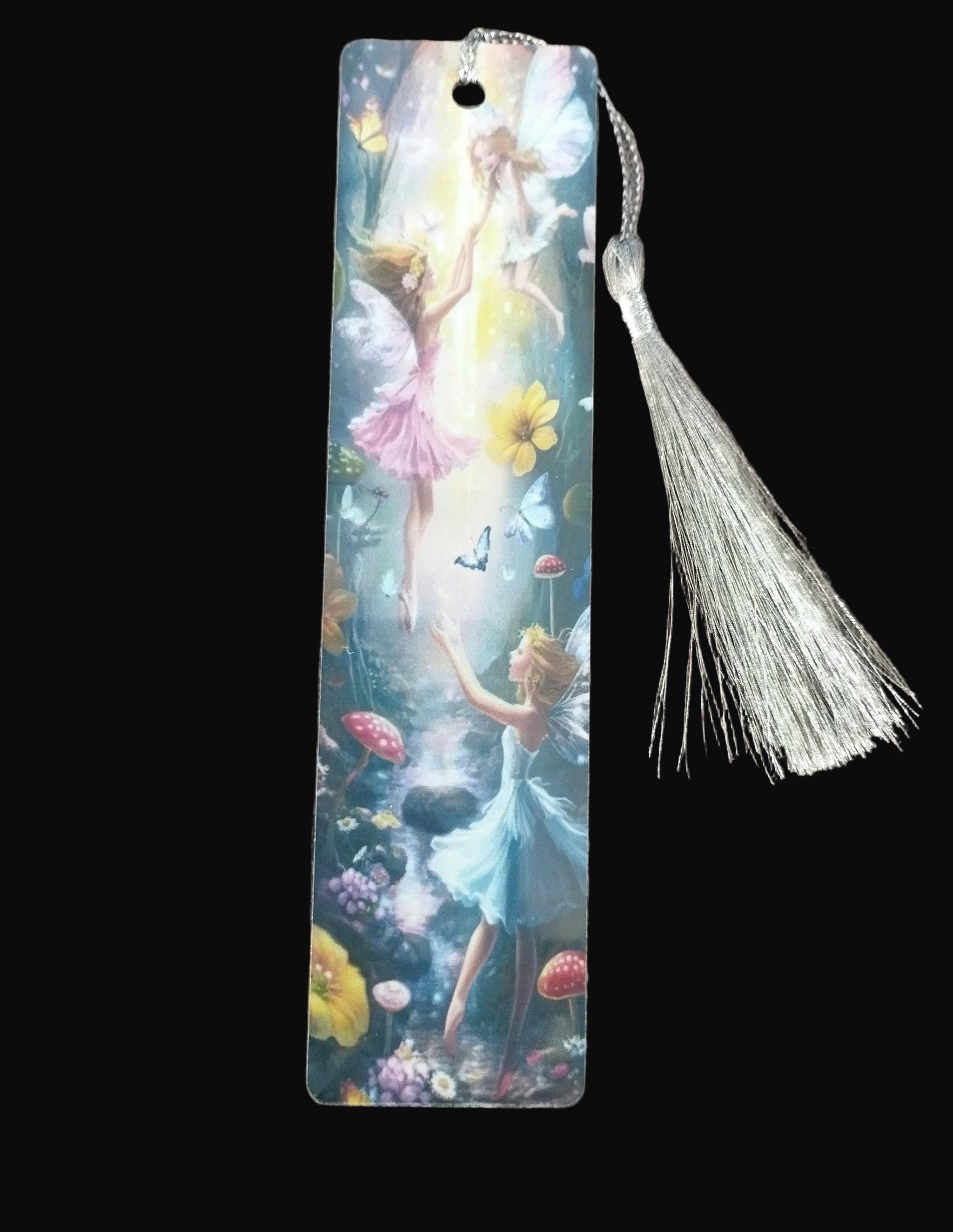 Fairy-themed bookmark with tassel on a wooden surface