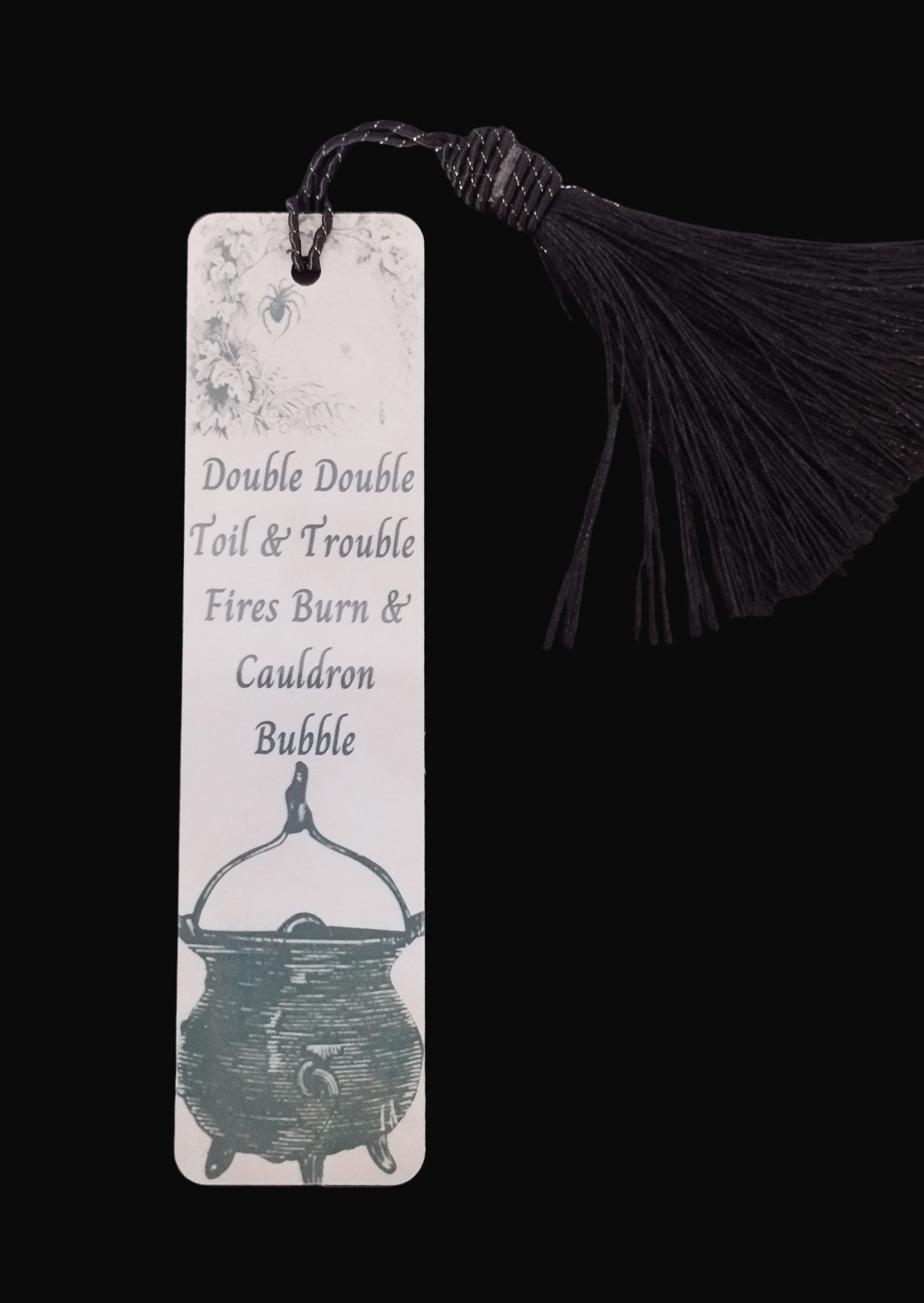 Bookmark with cauldron design and text on a dark background