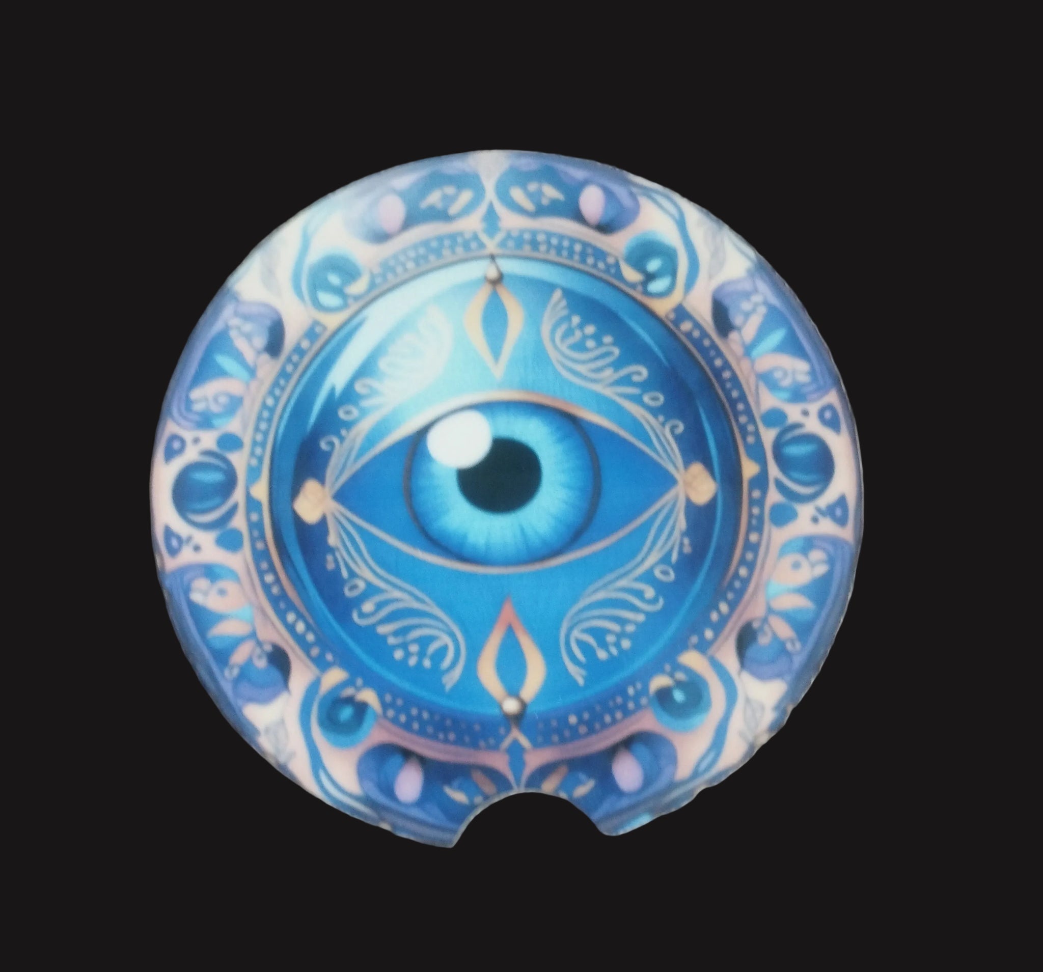 Decorative blue eye design on a wooden surface