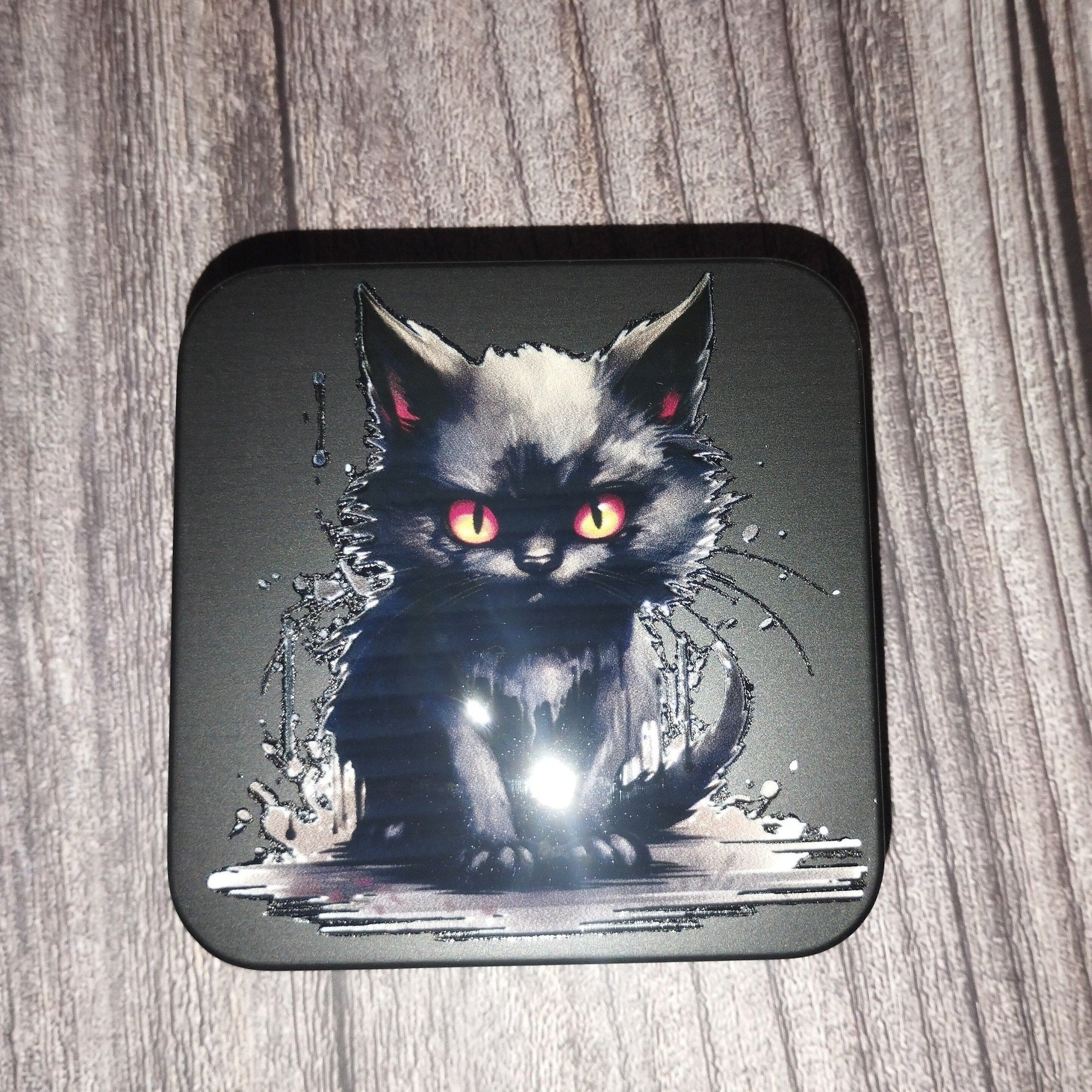 tin with a black cat design on a wooden surface