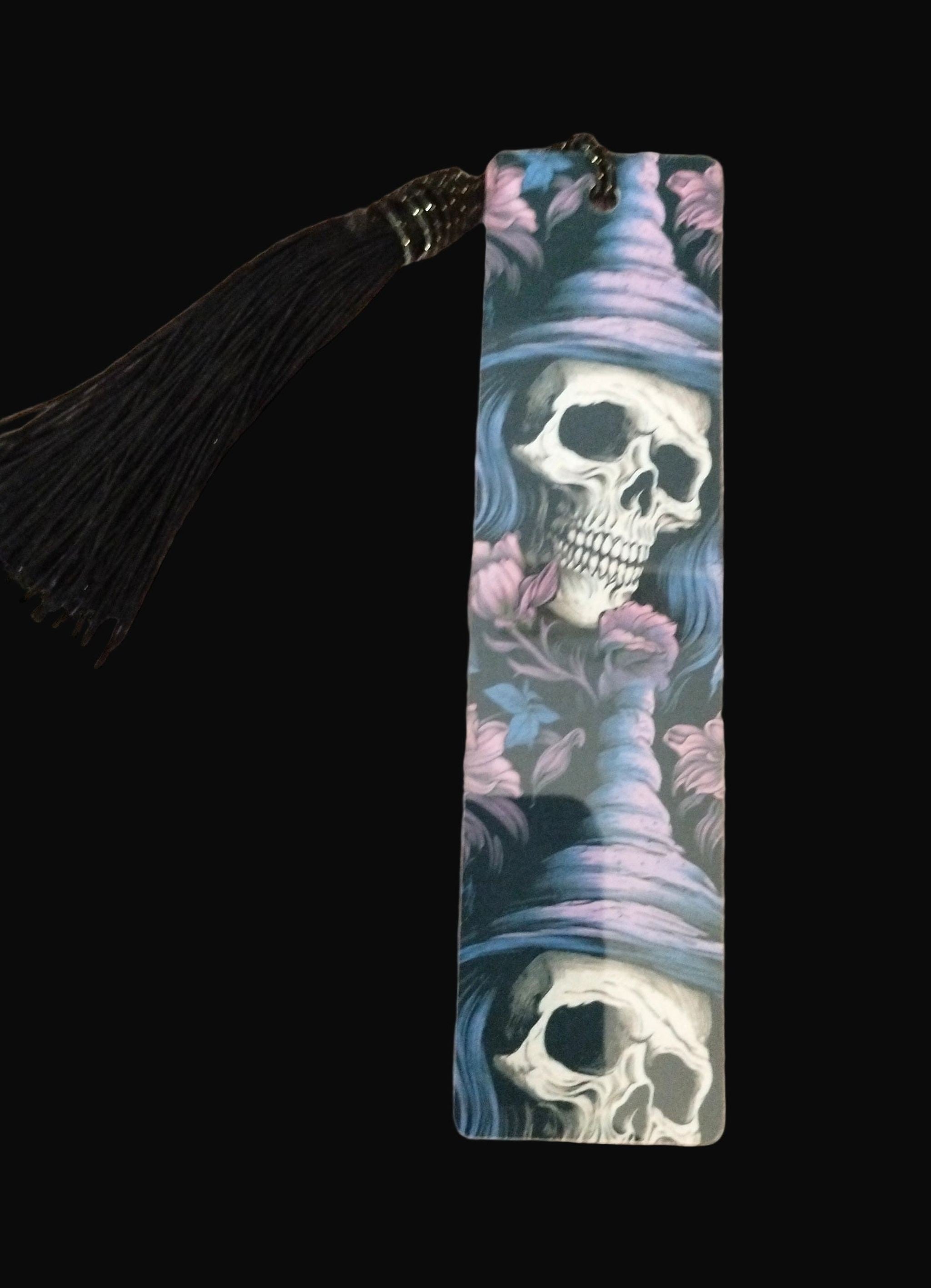 Bookmark with skull design and tassel on a wooden surface