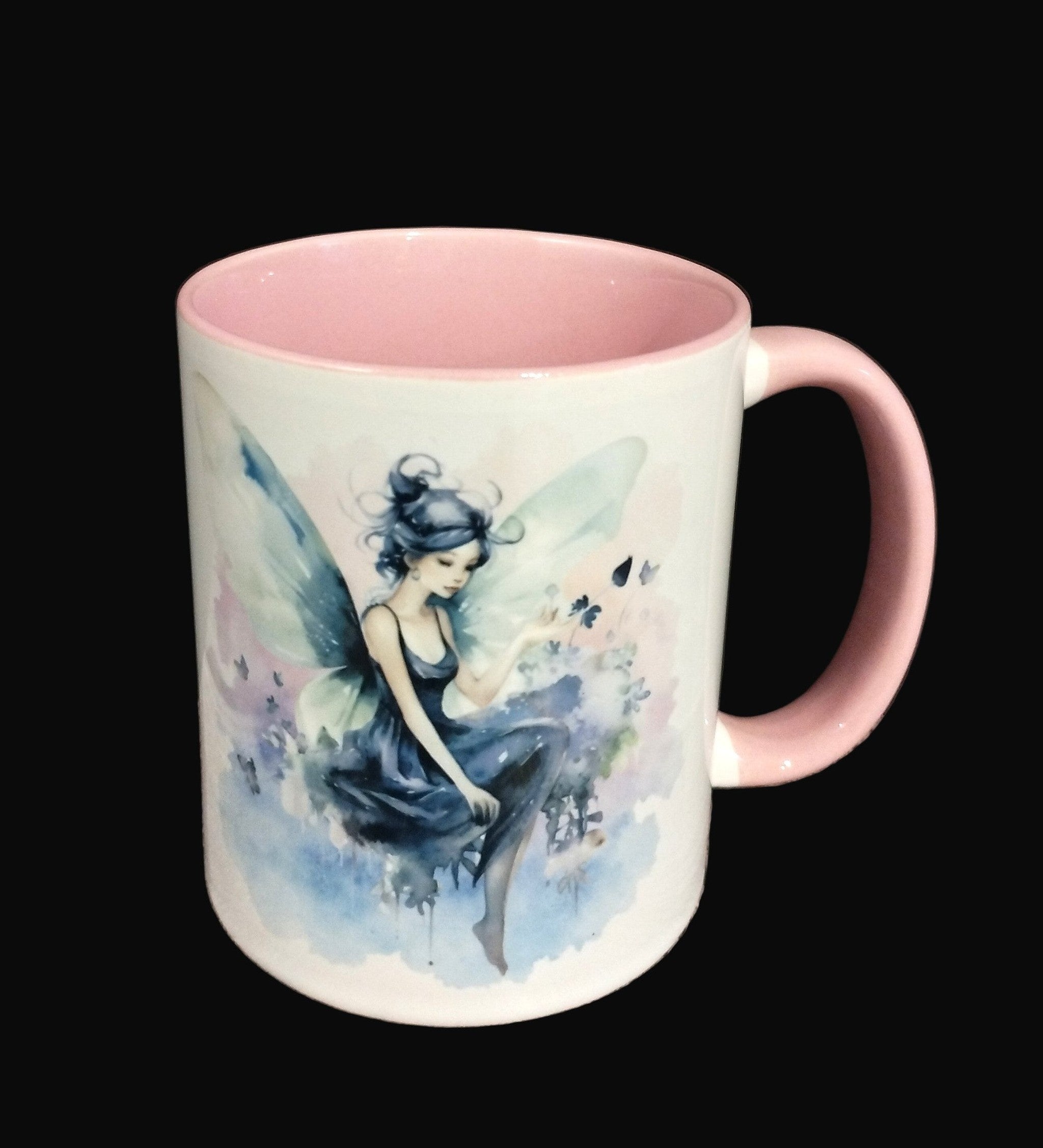Mug with fairy design on a wooden surface