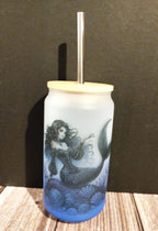 Tumbler with mermaid design on a wooden surface and dark background