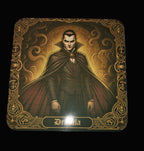 Card featuring a character in a dark cloak with ornate border on a wooden surface