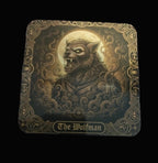 Decorative coaster with a wolfman design on a wooden surface
