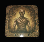 Decorative coaster with 'The Mummy' design on a wooden surface