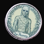 Coin with a mummy design on a wooden surface