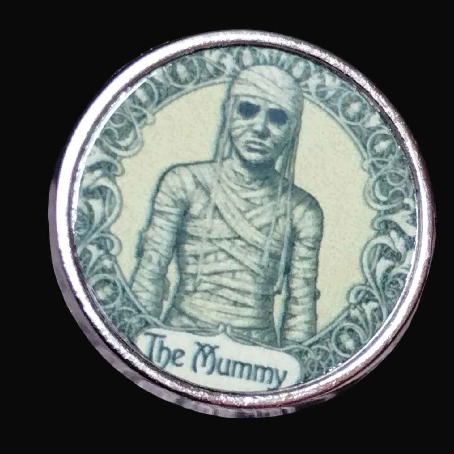 Coin with a mummy design on a wooden surface