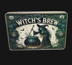 Decorative tin with 'Witch's Brew' design featuring a witch and cauldron on a wooden surface.