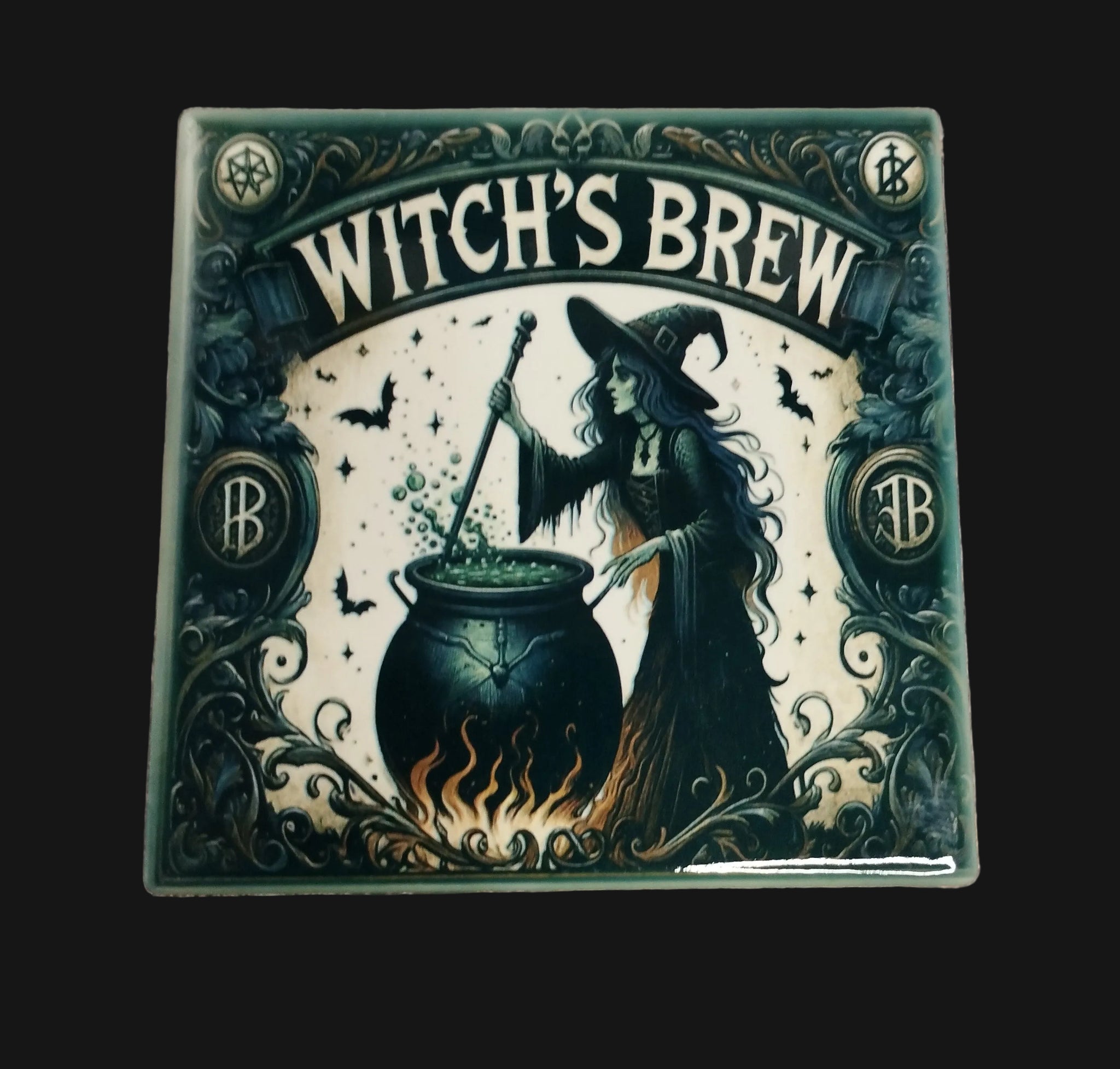 Decorative tile with a witch brewing potion design on a wooden background