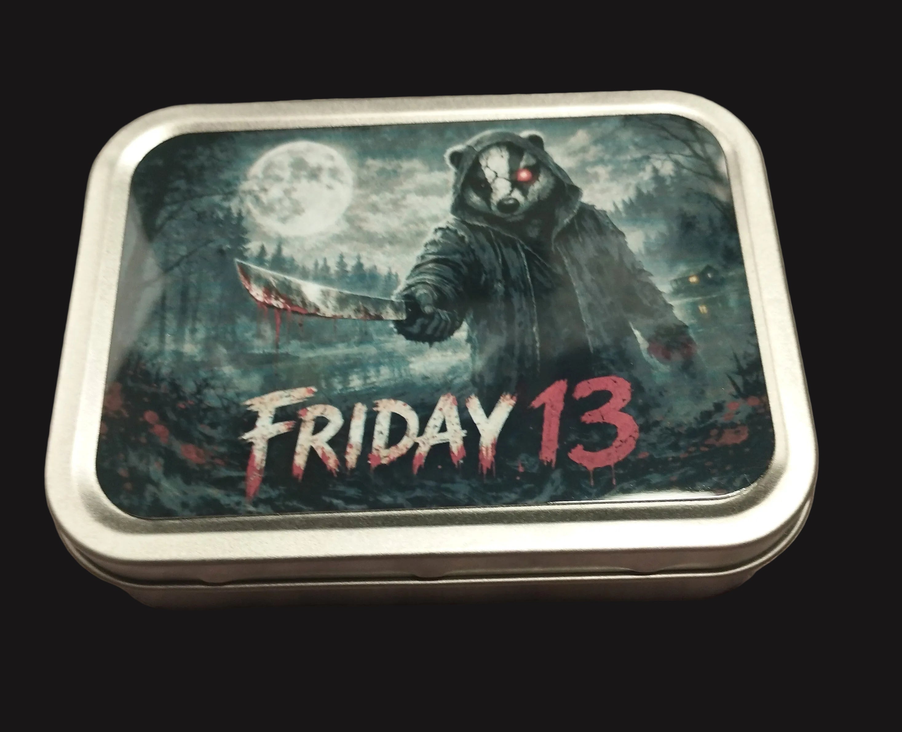 Tin box with 'Friday 13' design featuring a badger holding a knife on a wooden surface