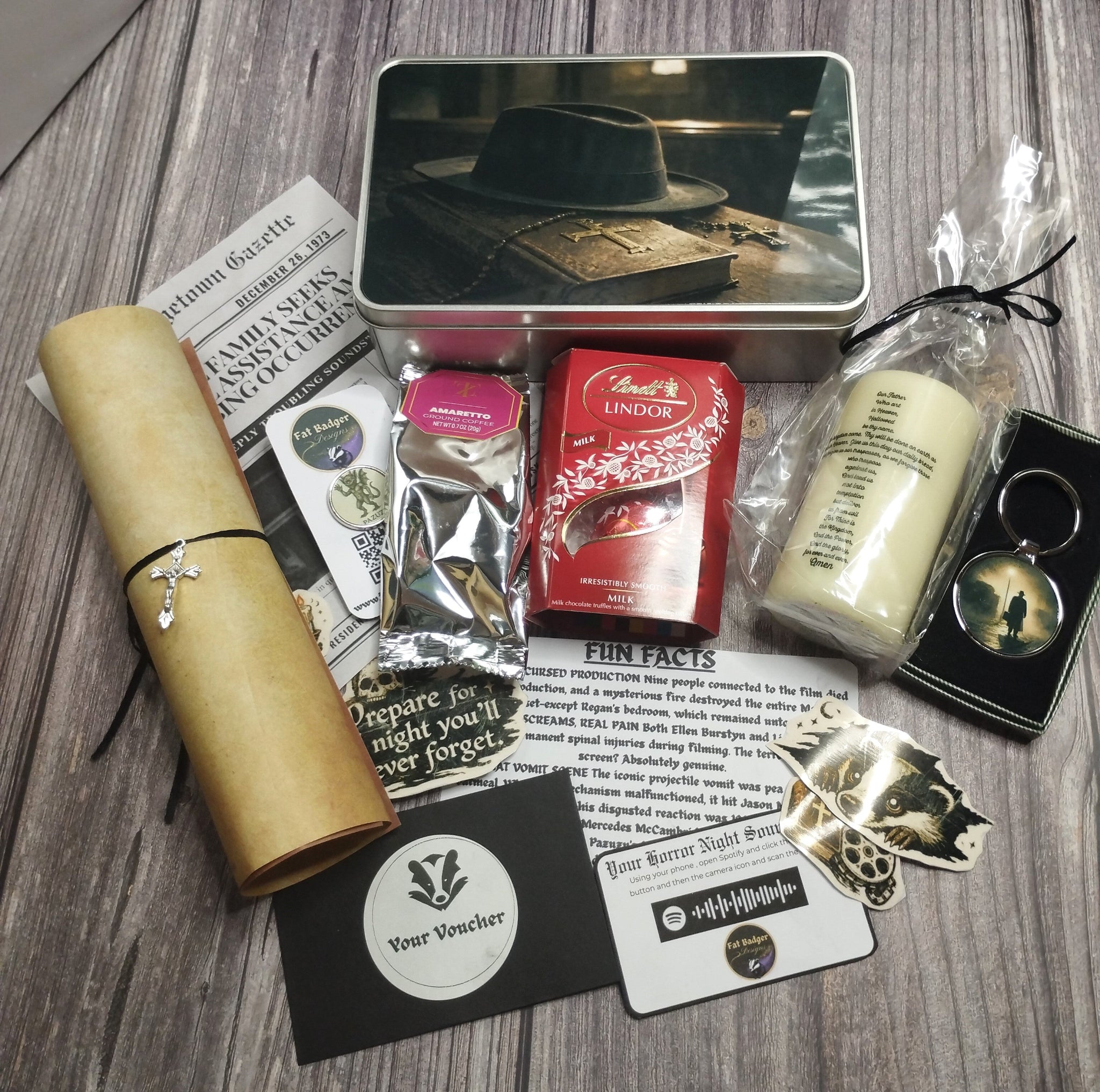 Collection of themed items including a hat tin, candle, keychain, and other decorative pieces on a wooden surface.