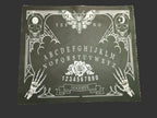 Ouija board design lens cloth on a wooden surface