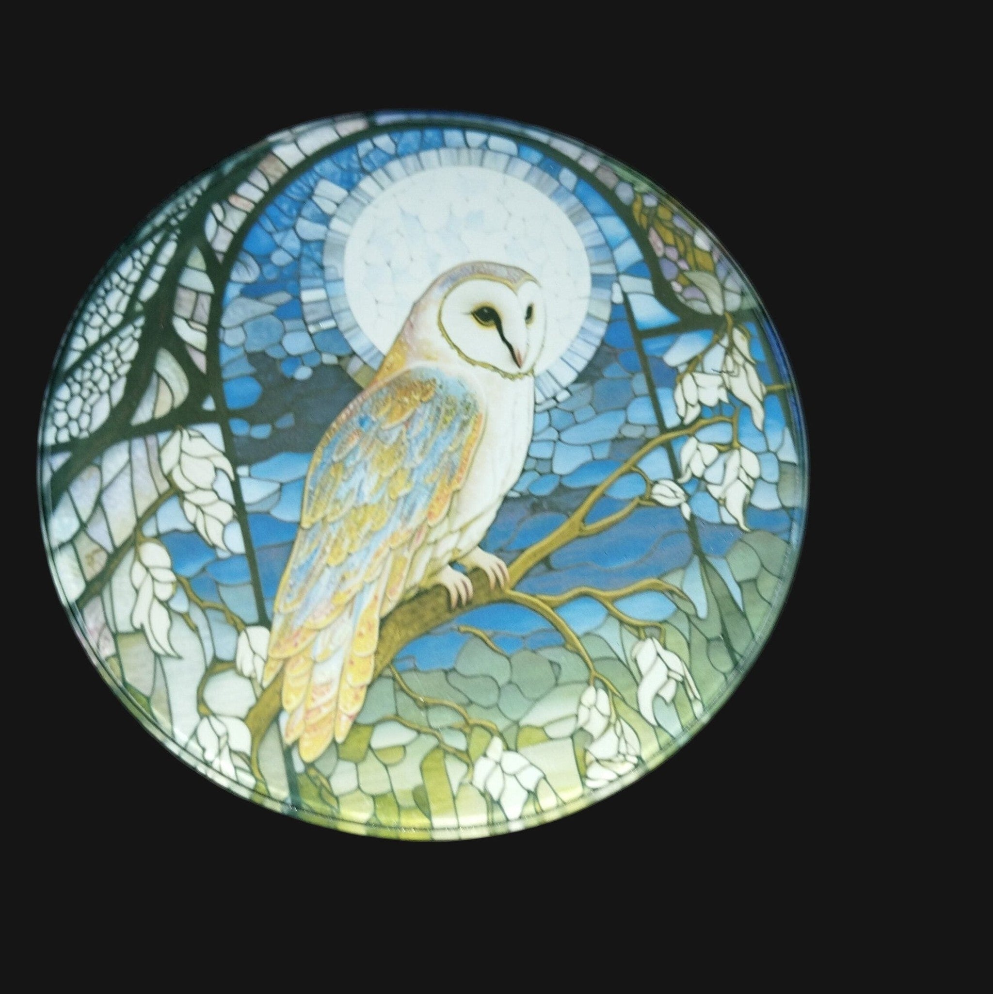 Stained glass mosaic of an owl on a dark background