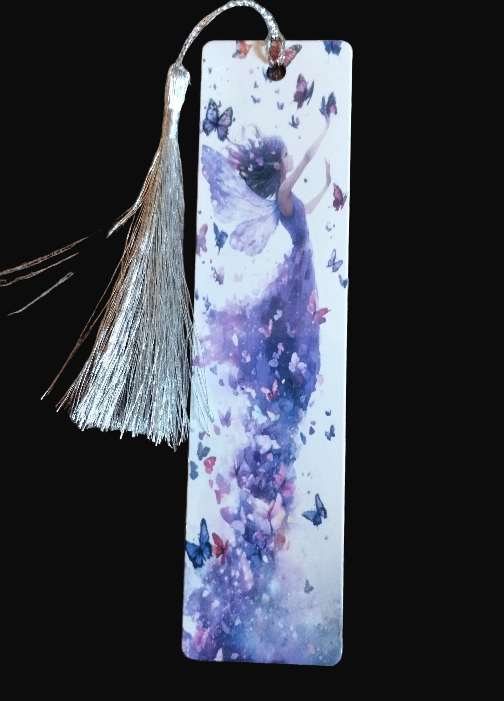 Bookmark with a design of a dancer and butterflies on a wooden surface