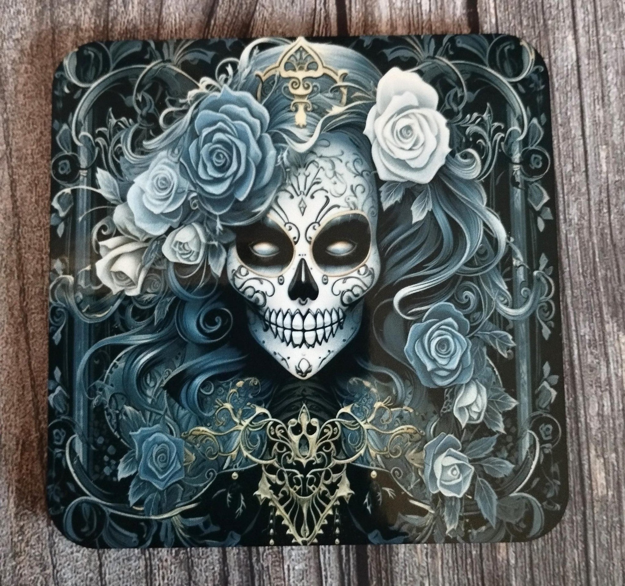 Decorative coaster with a skull and floral design on a wooden surface