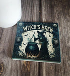 coaster  titled 'Witch's Brew' on a wooden surface with a white vase in the background.