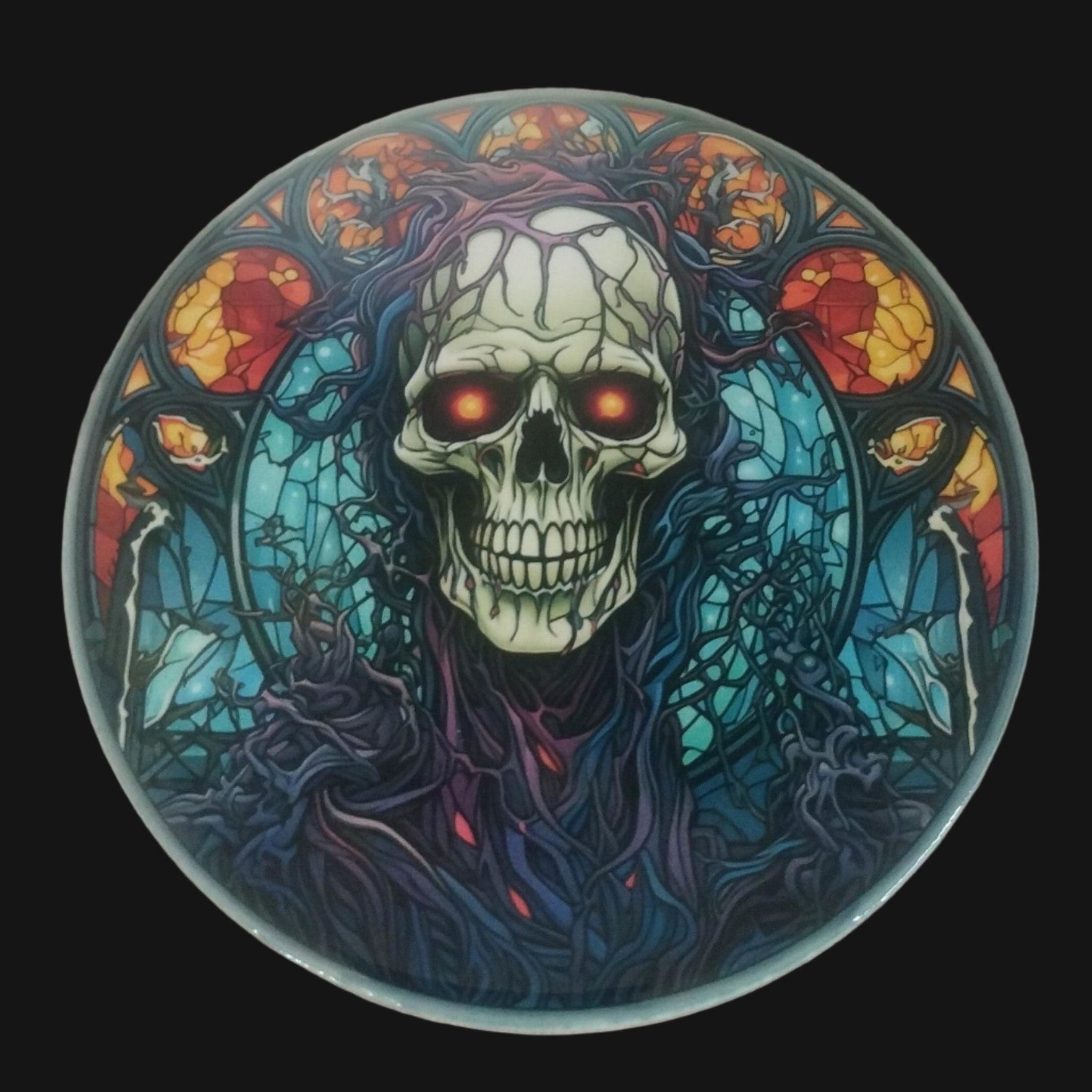 Circular coaster with a skull design on a wooden surface
