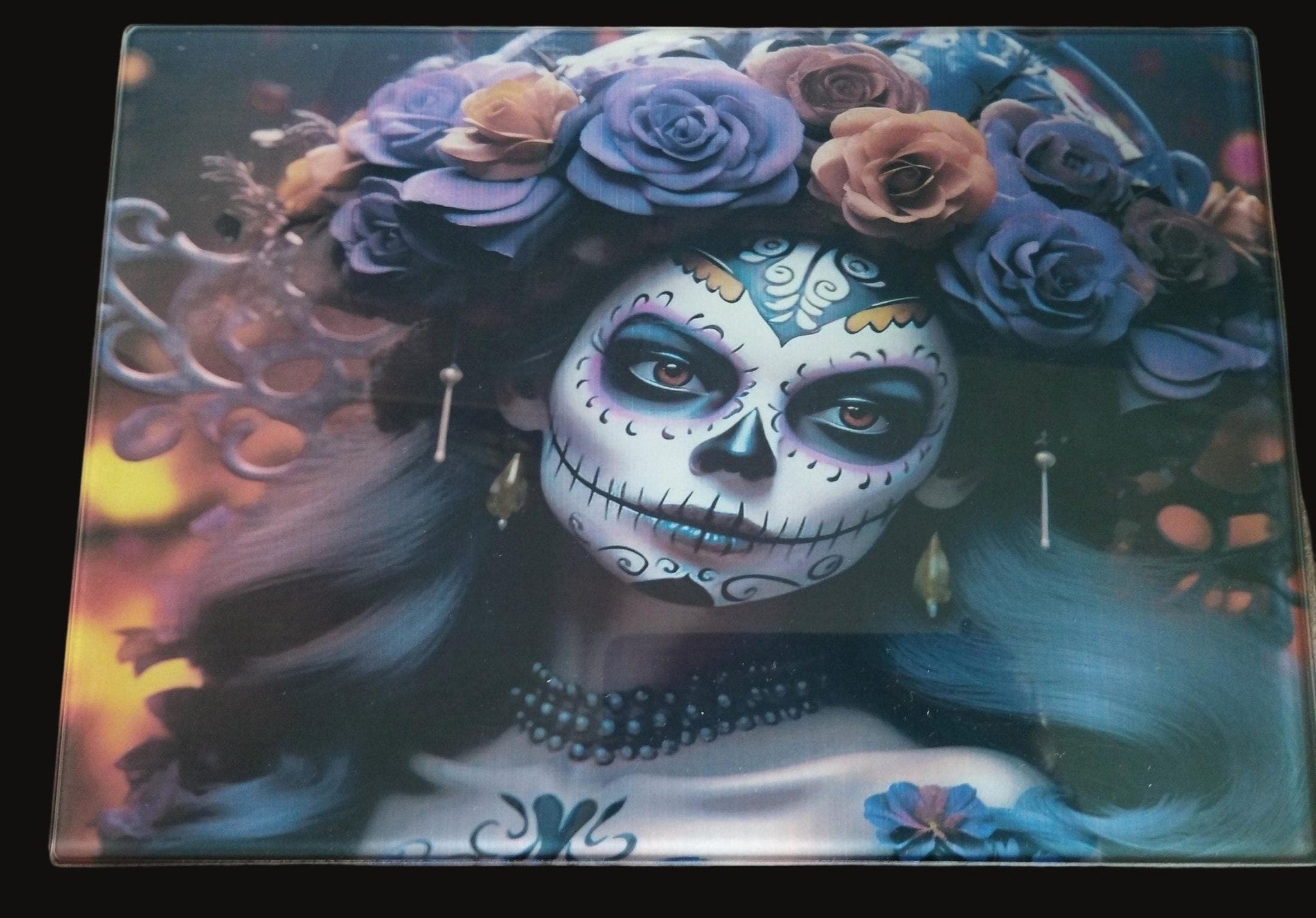 Decorative mat with a design of a woman with sugar skull makeup and floral headpiece on a wooden surface.
