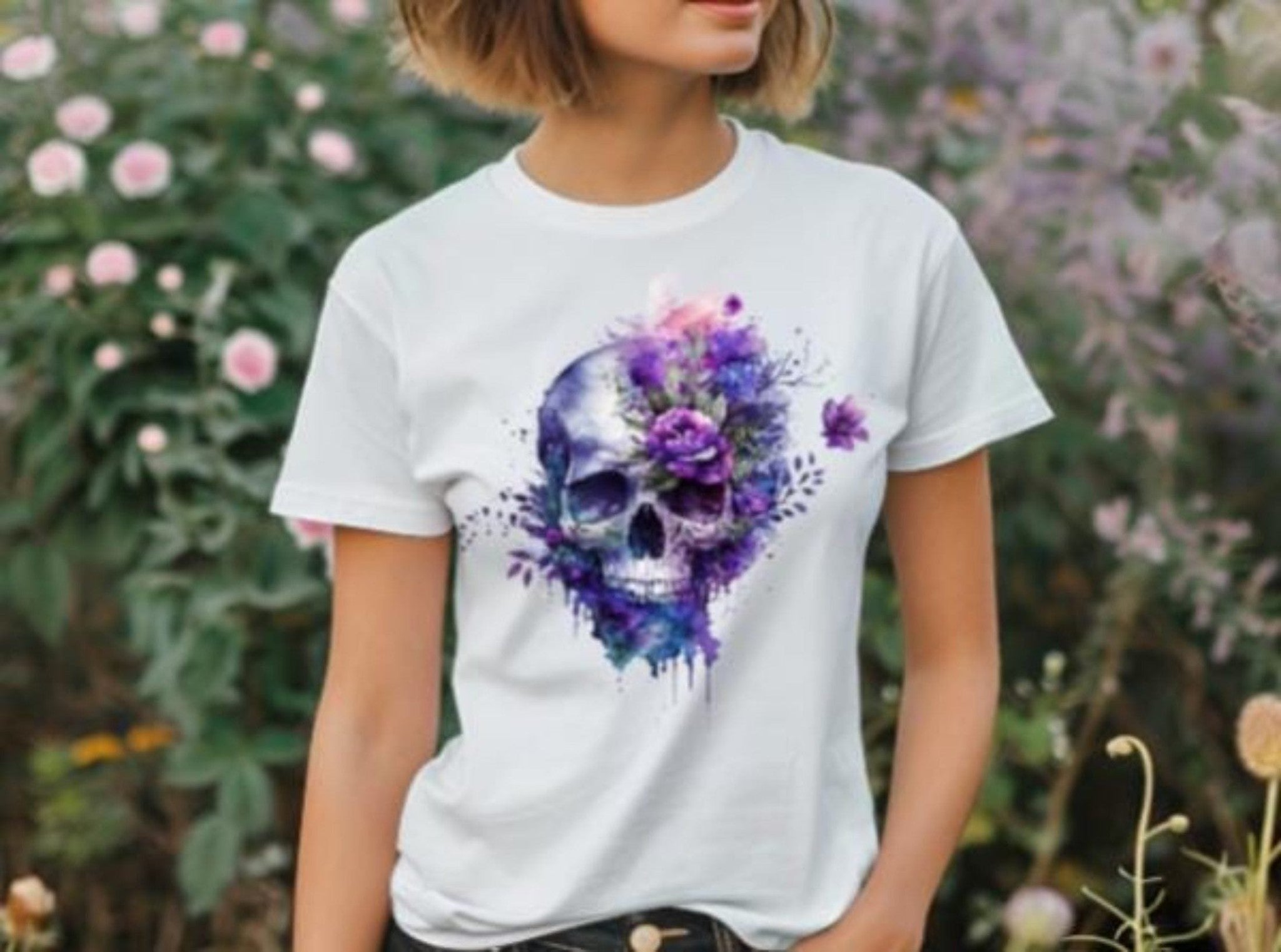 Person wearing a white t-shirt with a colorful skull and floral design outdoors.