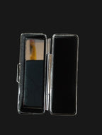 Black rectangular object with a reflective surface on a wooden surface