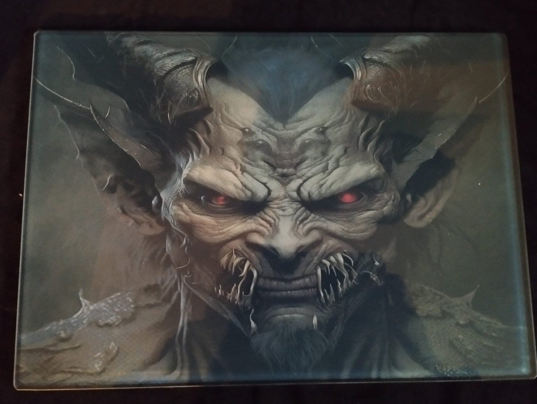 Artistic depiction of a demonic creature with glowing red eyes on a dark background