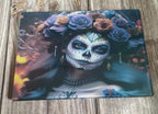 Decorative glass panel with a design of a woman with sugar skull makeup and floral headpiece on a wooden surface.