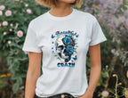 Person wearing a white t-shirt with a skull and floral design, text 'Beautiful Crazy' in a garden setting.