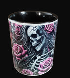 Mug with skull and rose design on a wooden surface