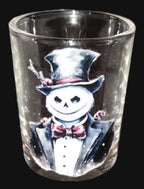 Clear glass shot glass with a snowman in a top hat and suit design.