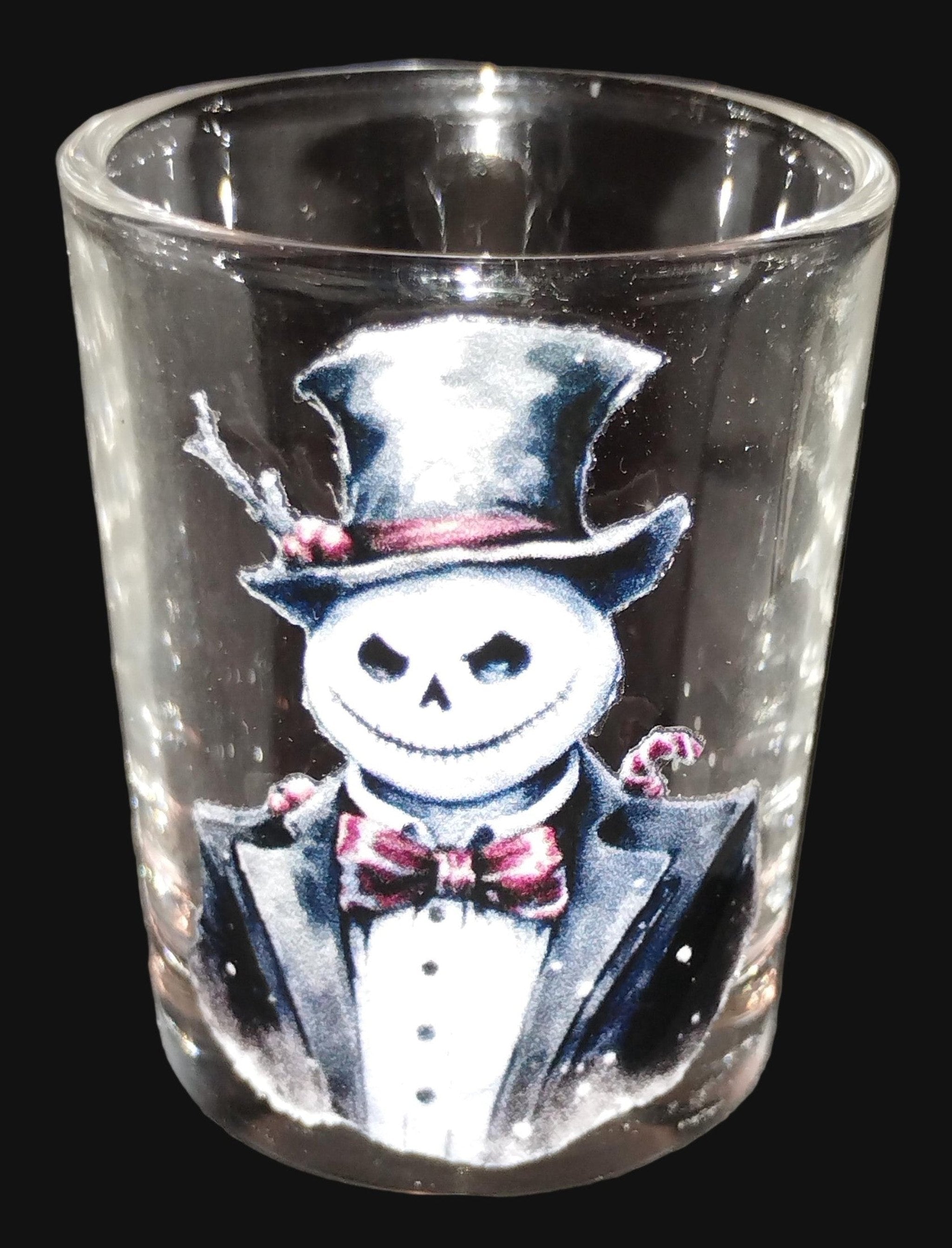 Clear glass shot glass with a snowman in a top hat and suit design.