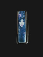 lipstick case with artistic design of a woman on a wooden surface