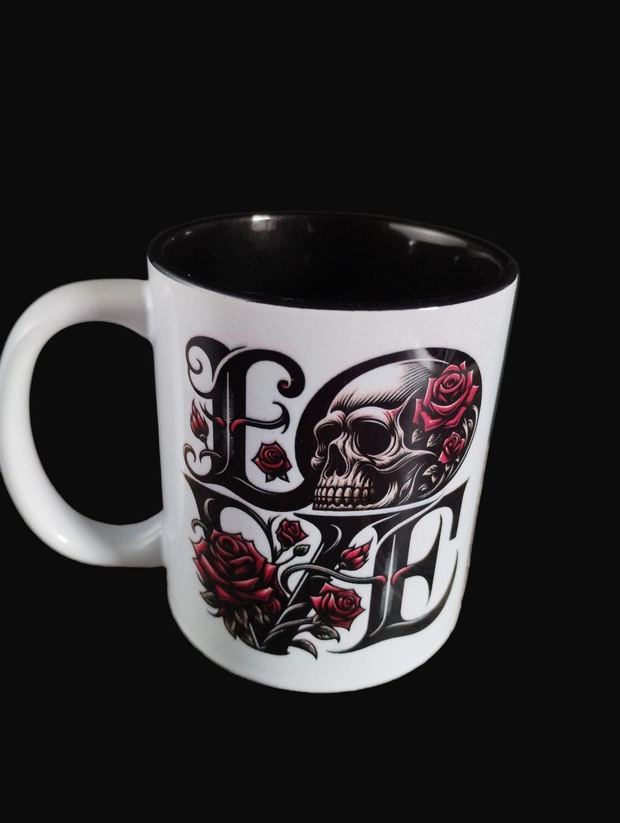 Mug with skull and roses design on a wooden surface