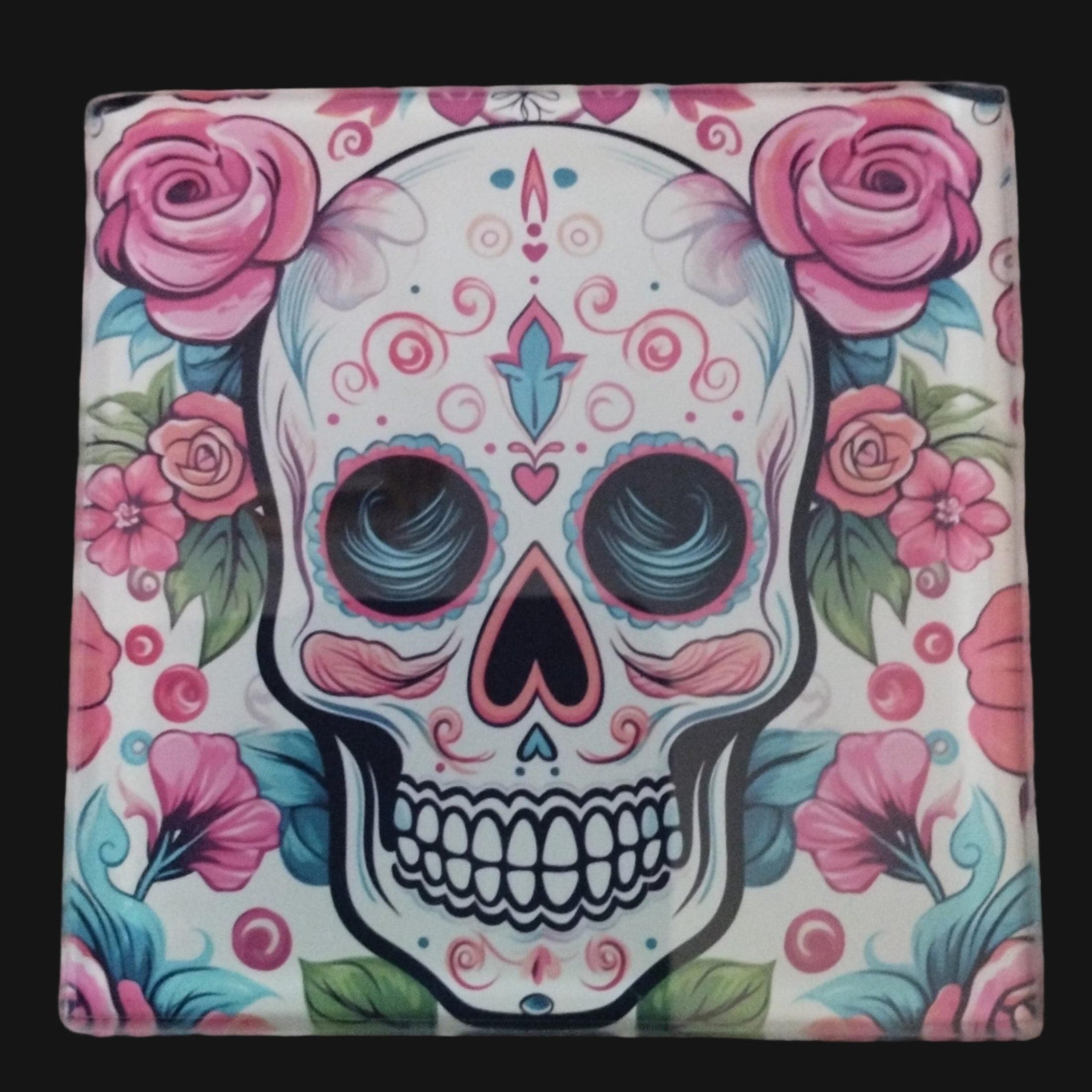 Colorful skull design with pink flowers on a wooden surface