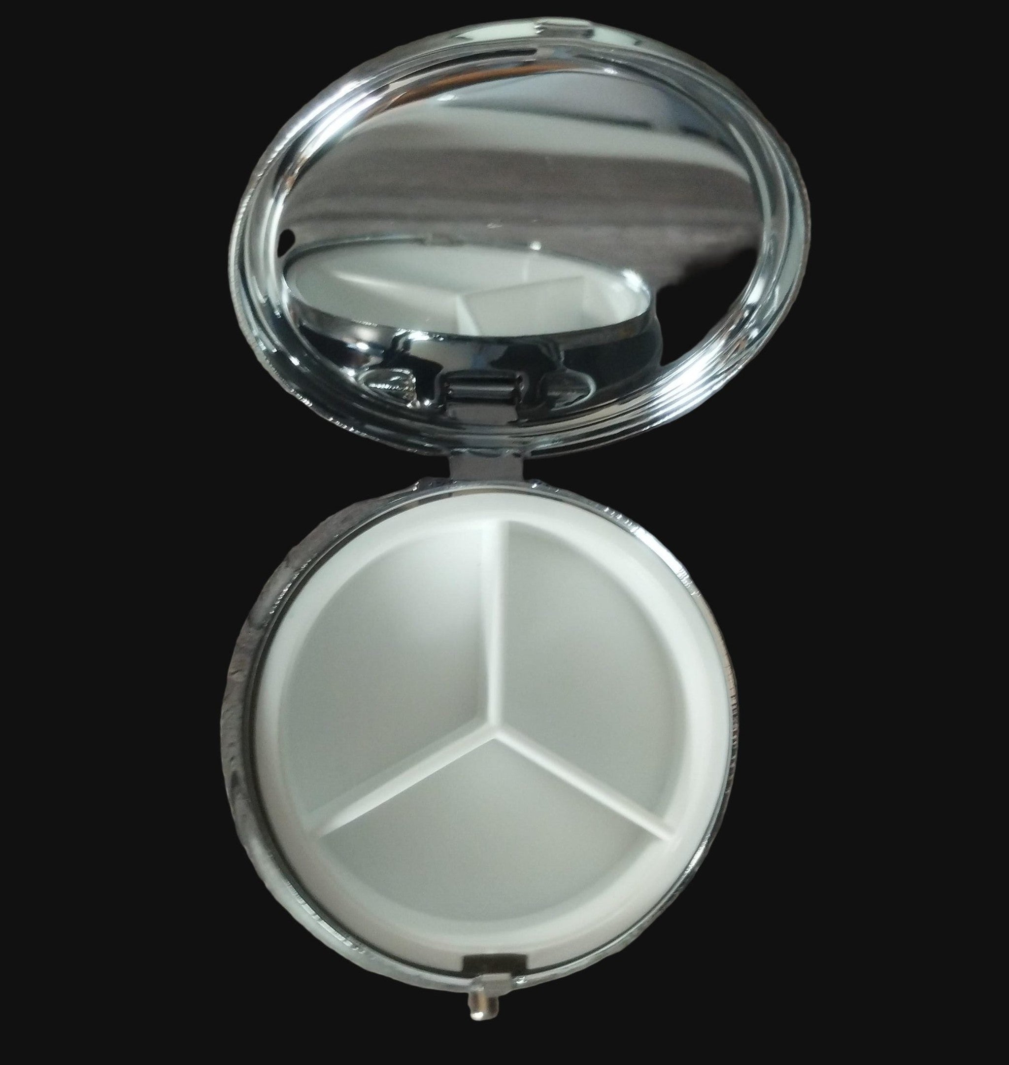 Pill Tin with three compartments on a wooden surface