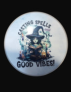 Circular sign with a witch holding a book and text 'Casting Spells and Good Vibes' on a dark background.