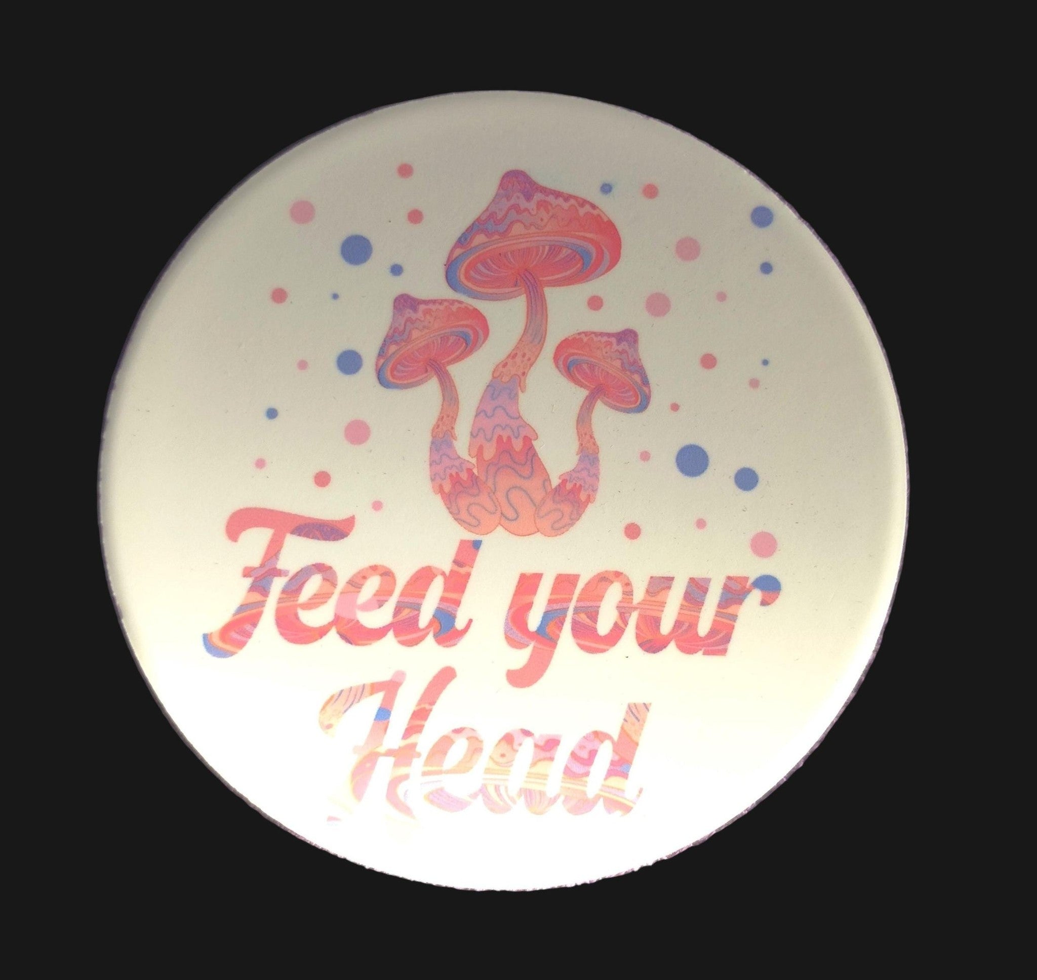 Round plate with colorful mushroom design and 'Feed your Head' text on a purple textured background