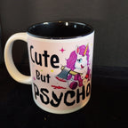 Mug with unicorn design and text 'Cute But Psycho' on a dark background
