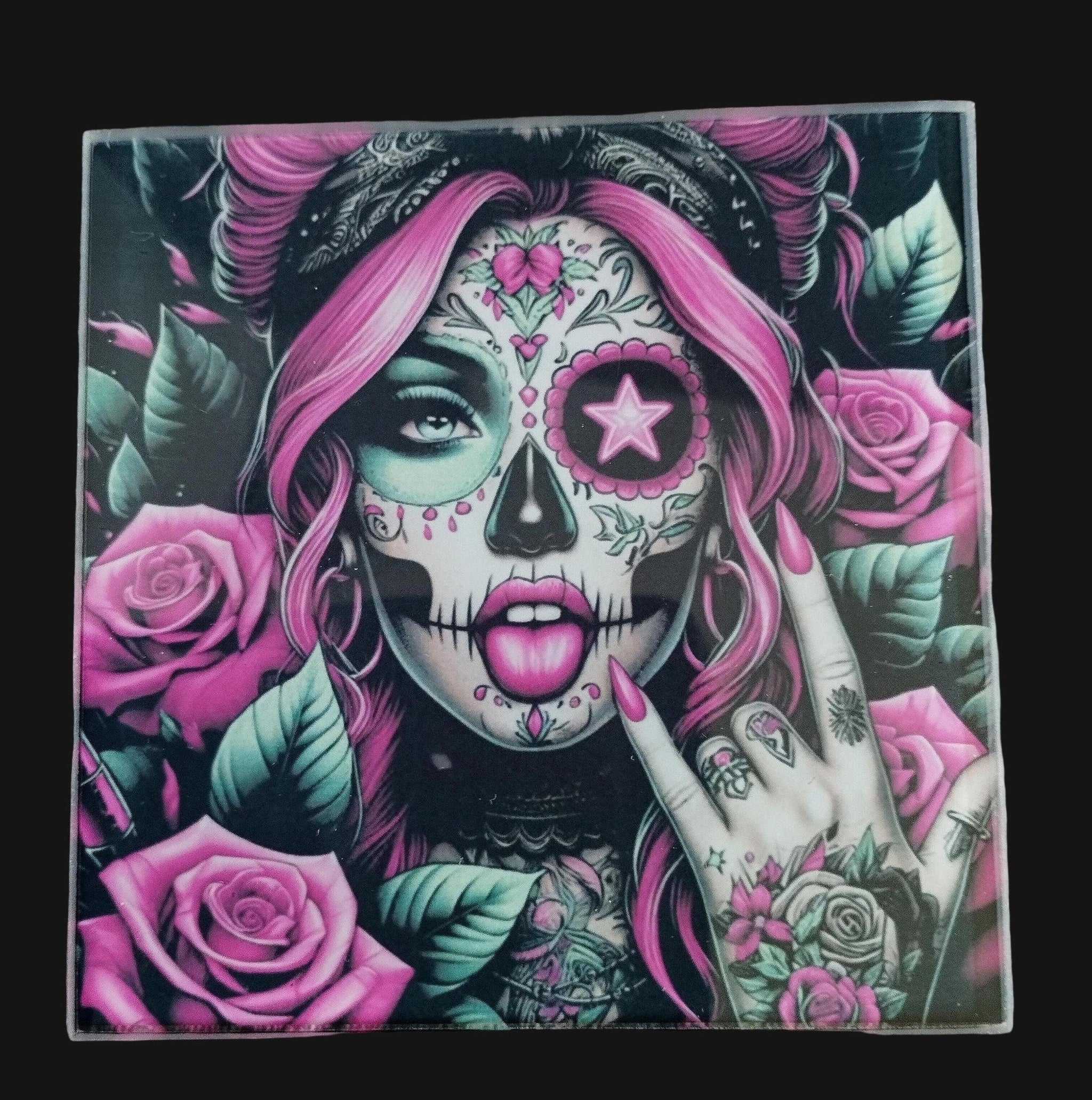 Artistic depiction of a person with a sugar skull design, surrounded by pink and green roses on a wooden surface.