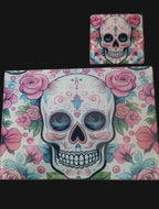 Colorful skull design with pink roses on a wooden surface