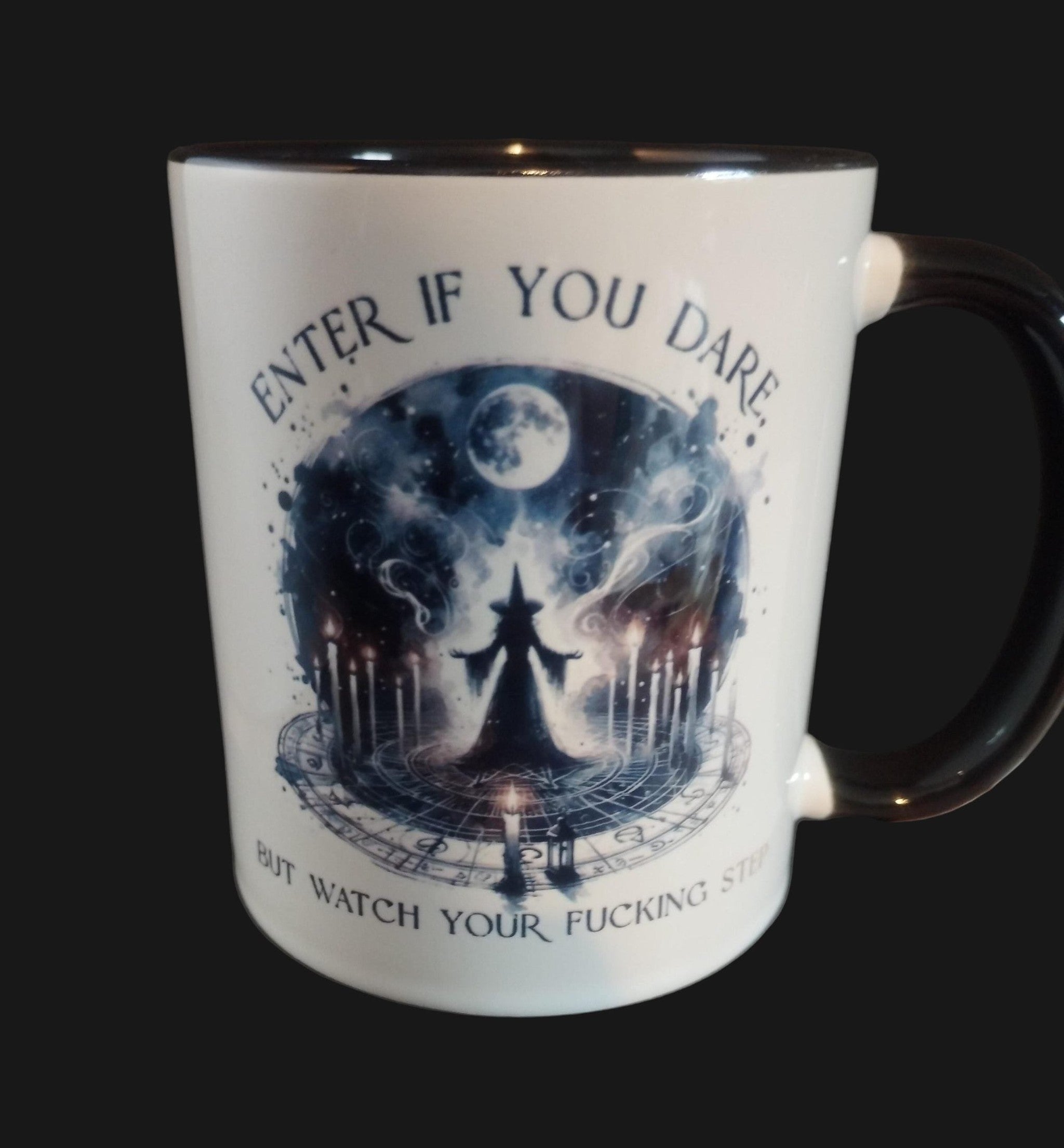 Mug with a dark fantasy design and text on a wooden surface