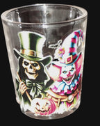 Glass with Halloween-themed design of a skeleton and clown.