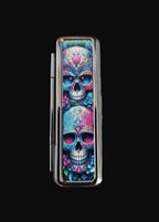 Colorful skull design on a metallic case against a wooden background