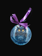 Decorative owl ornament with a purple ribbon on a wooden surface