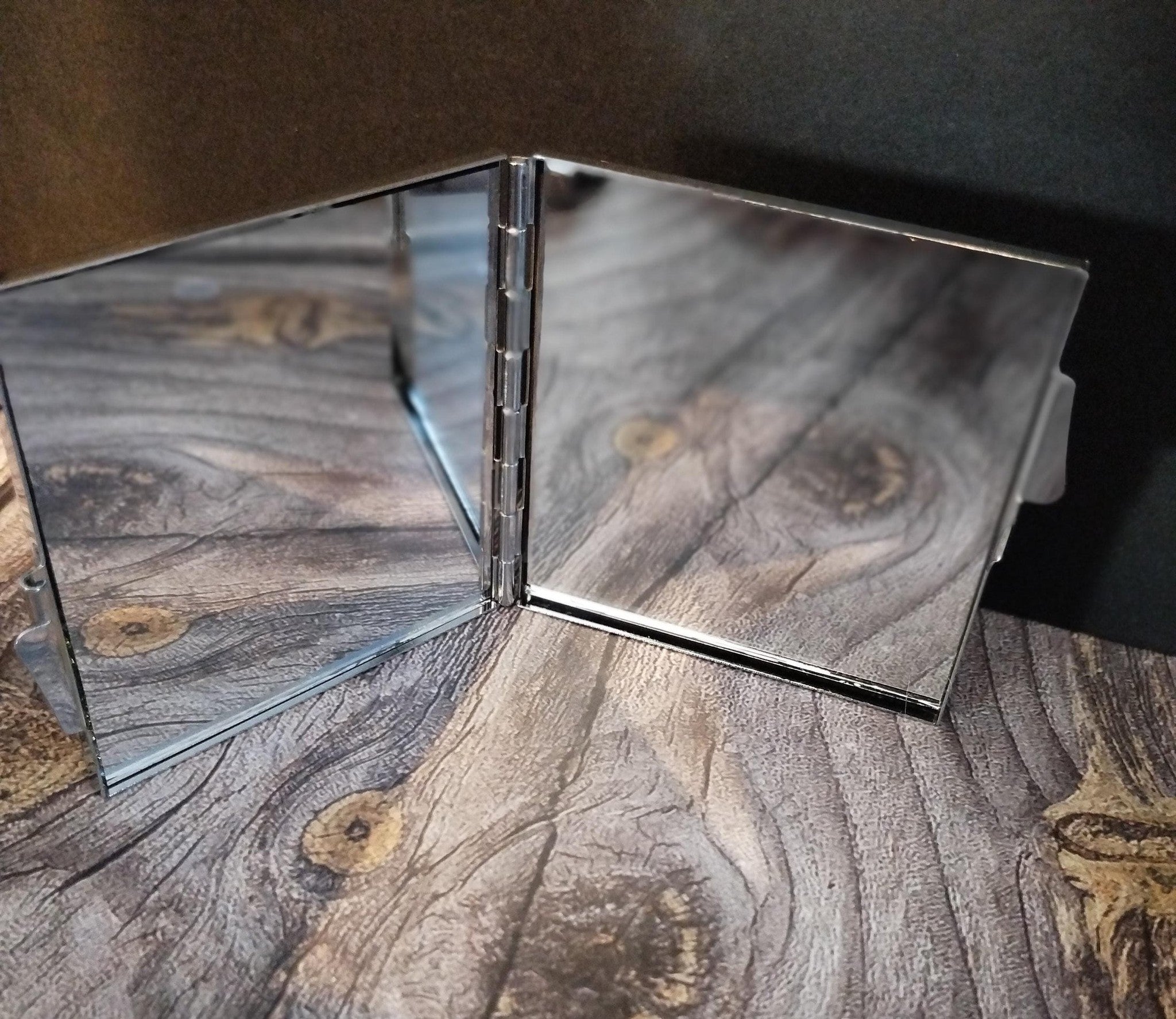 Foldable mirror with wooden texture on a wooden surface