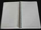 Open notebook with lined pages on a wooden surface